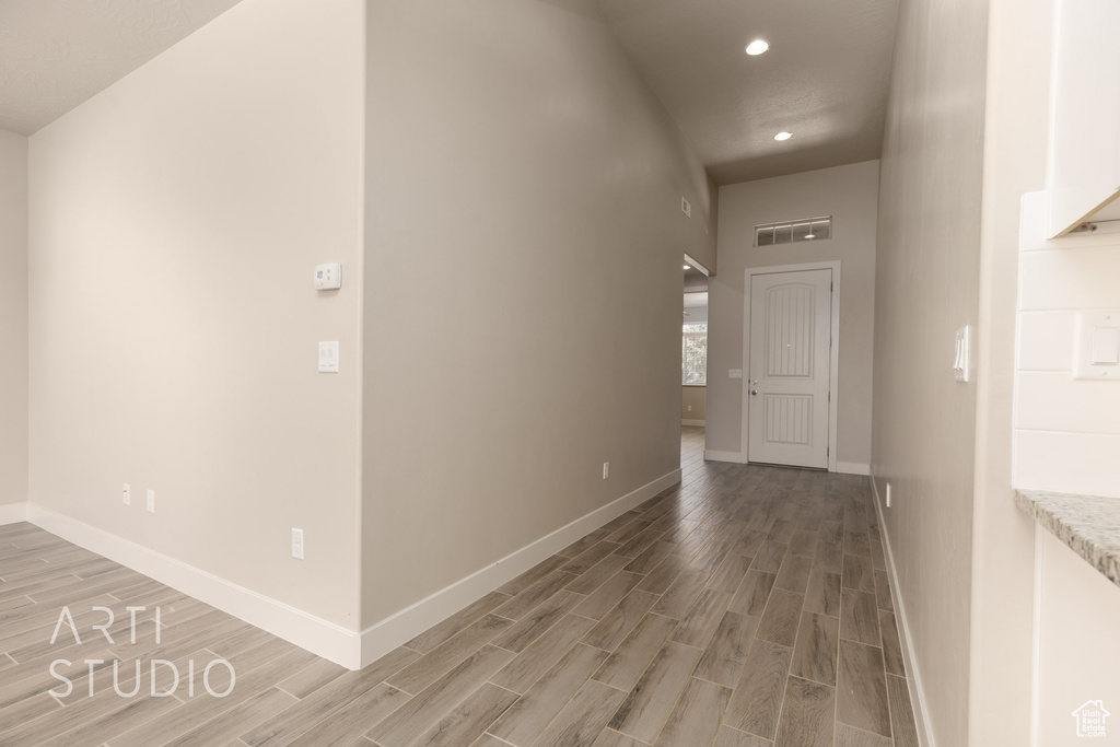 Hallway with hardwood / wood-style flooring