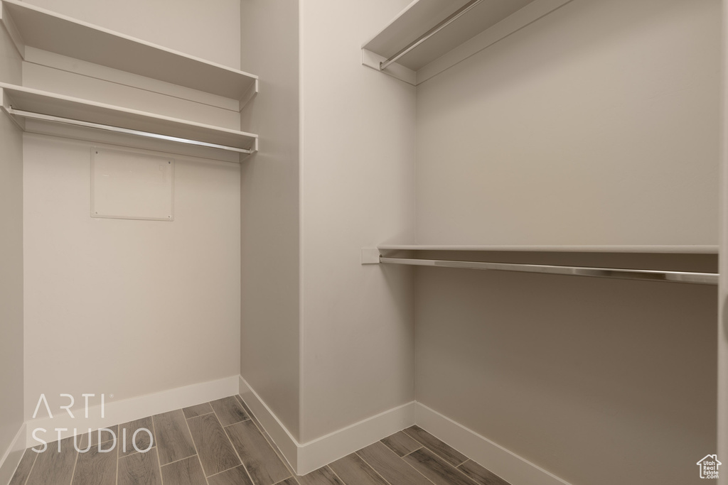 Walk in closet featuring dark hardwood / wood-style flooring