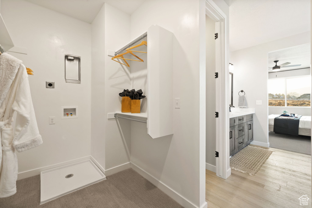 Interior space featuring wood-type flooring, ceiling fan, and vanity