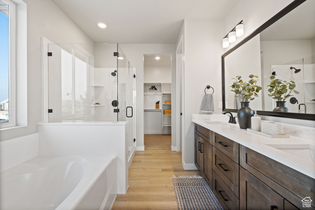 Bathroom with vanity, plus walk in shower, and hardwood / wood-style floors