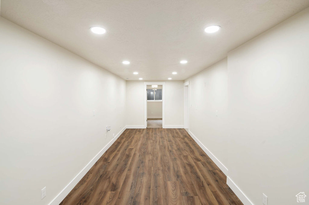 Empty room featuring dark wood-type flooring