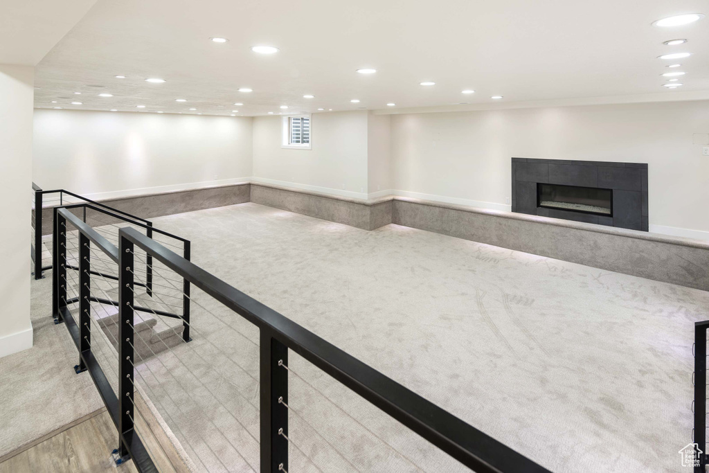 Interior space featuring light colored carpet and a tile fireplace