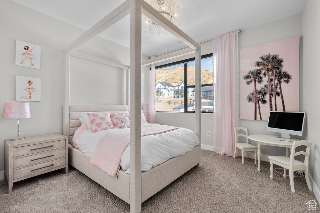 Carpeted bedroom with a chandelier