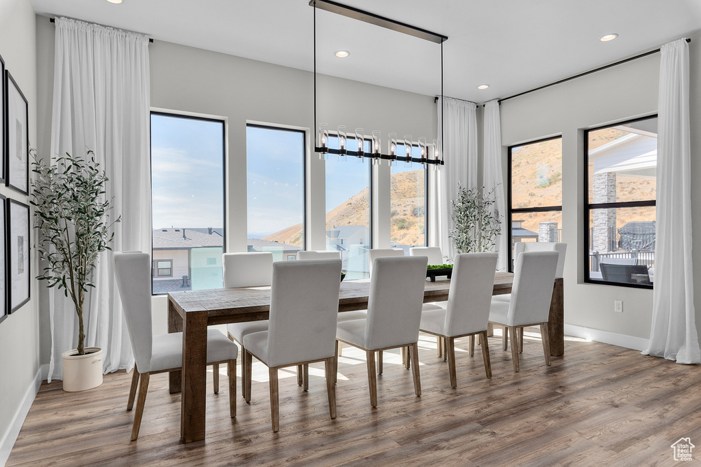 Dining area with a mountain view and hardwood / wood-style floors