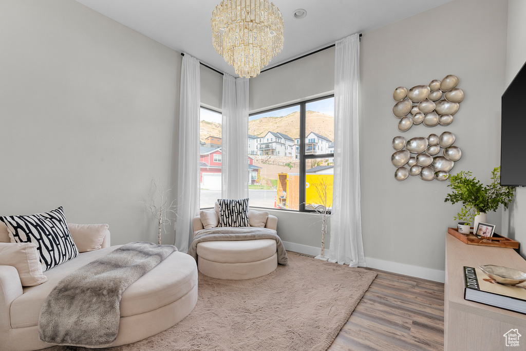 Living area featuring hardwood / wood-style flooring and a notable chandelier