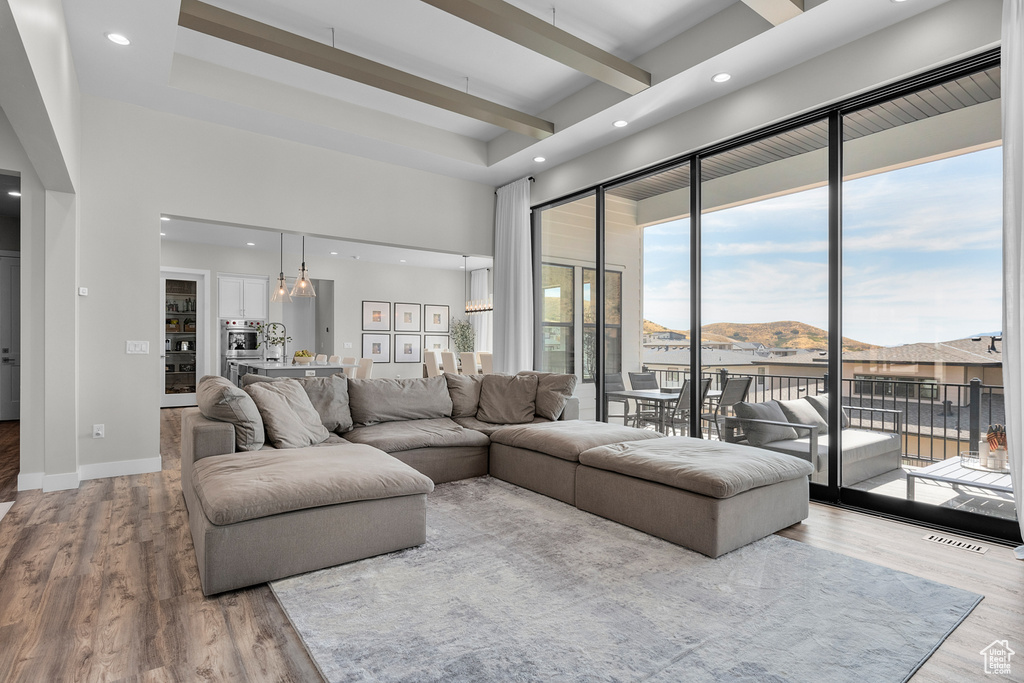 Living room featuring an inviting chandelier, light wood-type flooring, and a mountain view