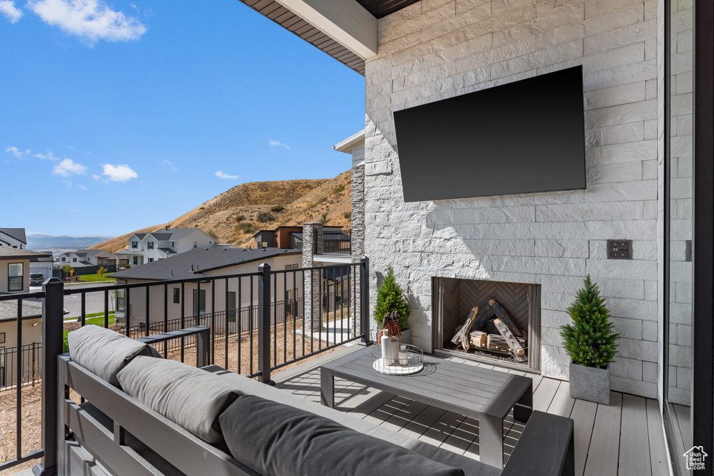 Balcony with an outdoor living space with a fireplace