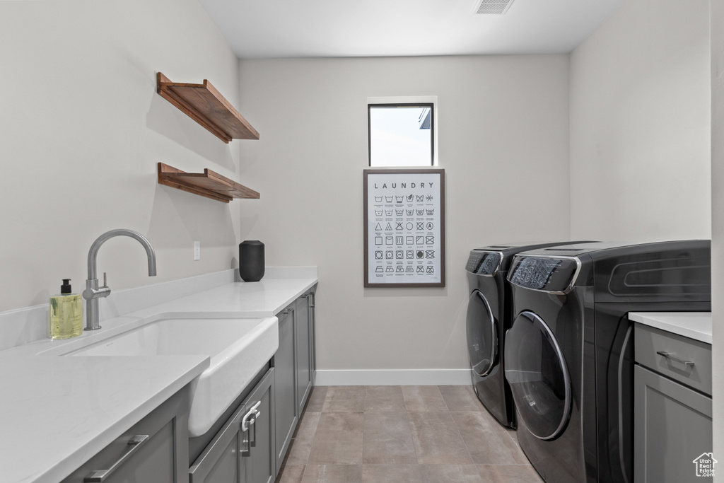 Washroom with cabinets, sink, and independent washer and dryer