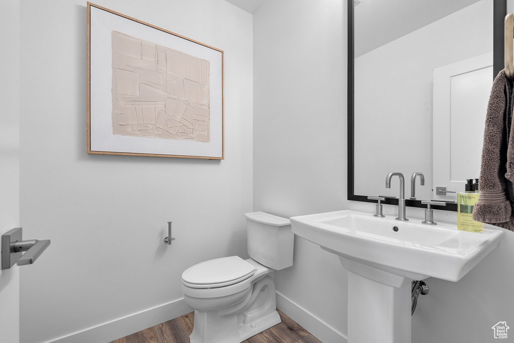 Bathroom featuring hardwood / wood-style floors and toilet