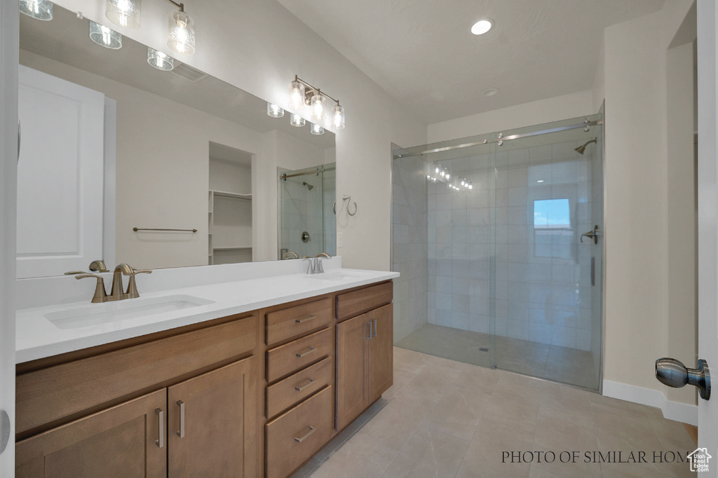 Bathroom with tile patterned flooring, vanity, and an enclosed shower