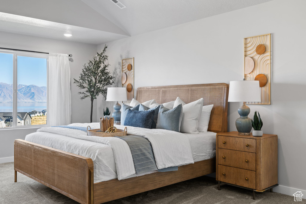 Carpeted bedroom with lofted ceiling and a mountain view