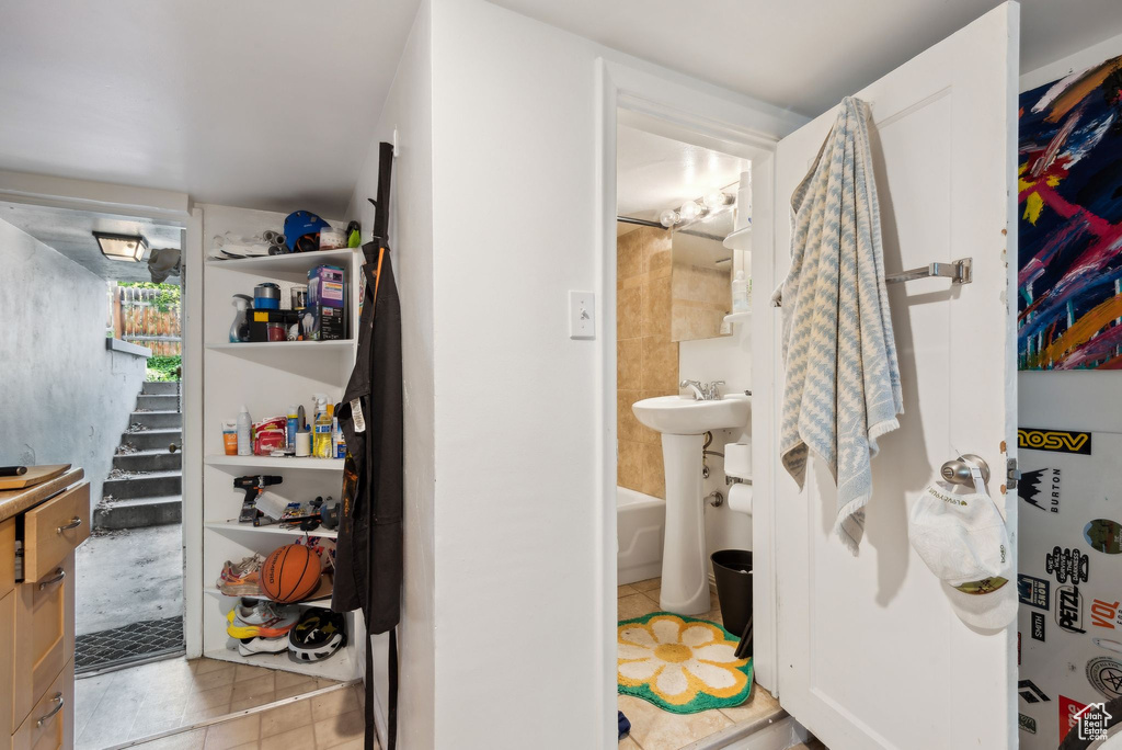 Interior space featuring sink and light tile patterned floors