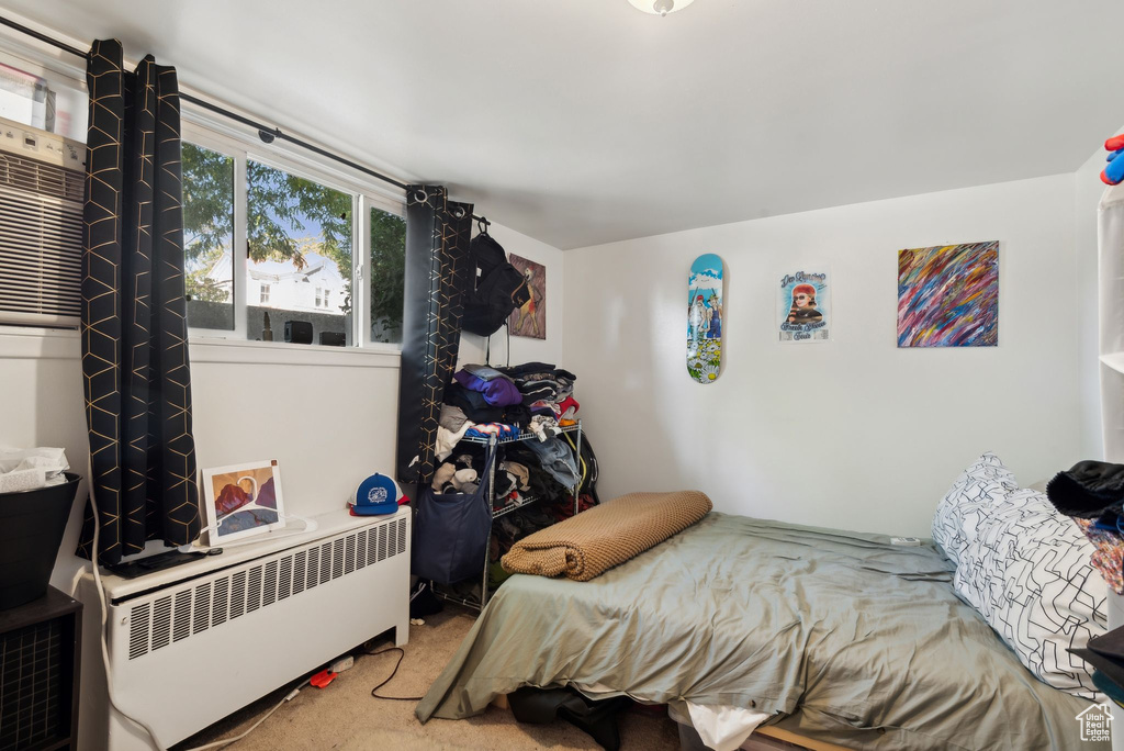 Carpeted bedroom with radiator