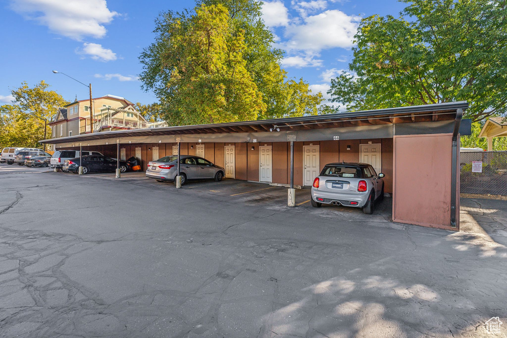 View of parking / parking lot with a carport