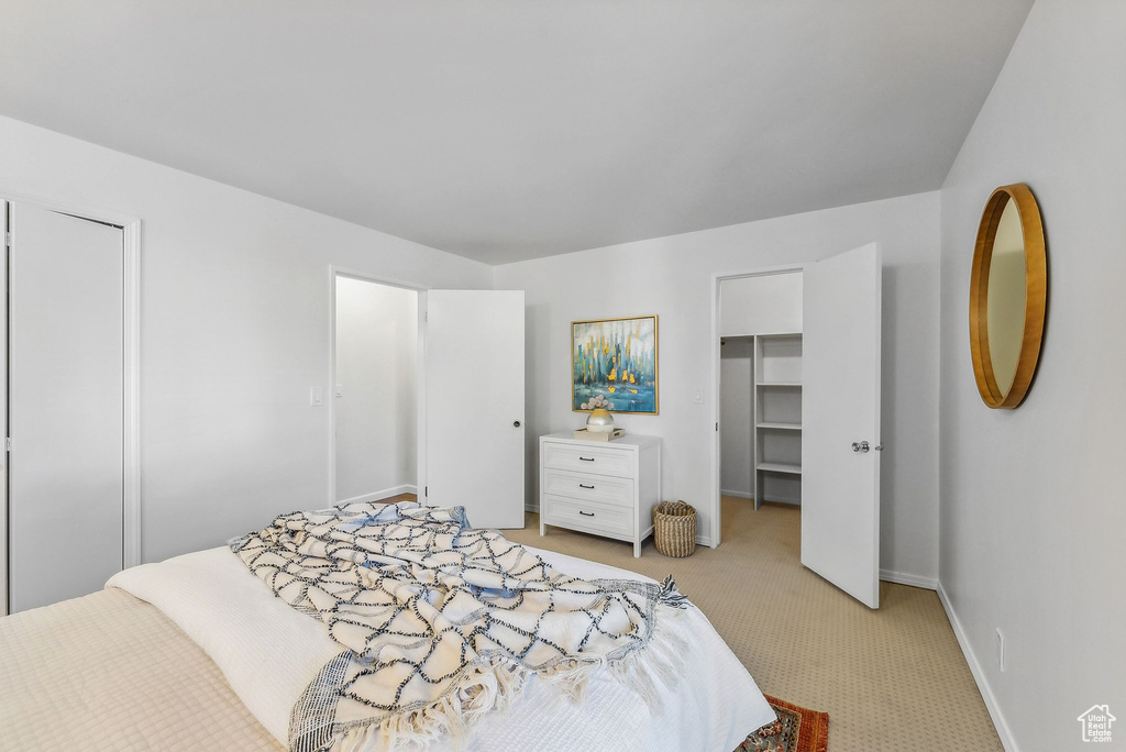 Bedroom featuring light colored carpet