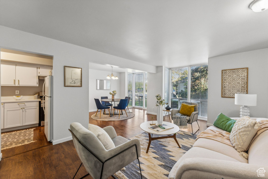 Living room with light hardwood / wood-style floors and a chandelier