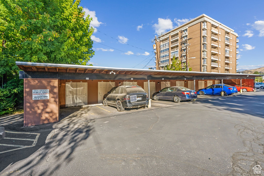 View of vehicle parking featuring a carport