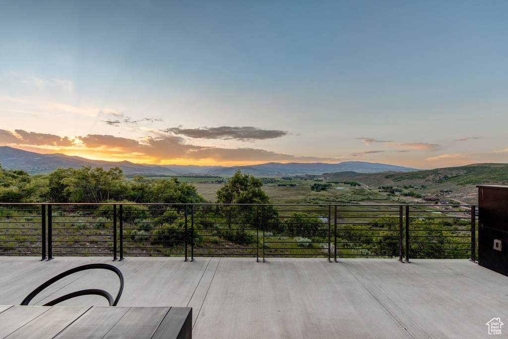 Patio terrace at dusk with a mountain view