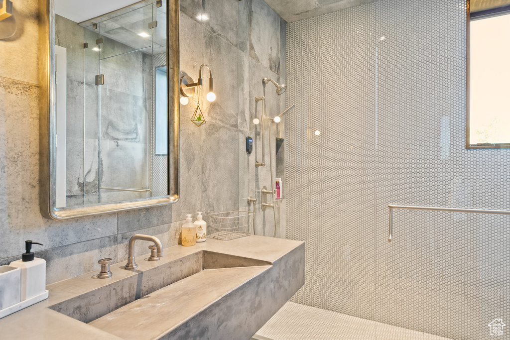 Bathroom with a tile shower and vanity