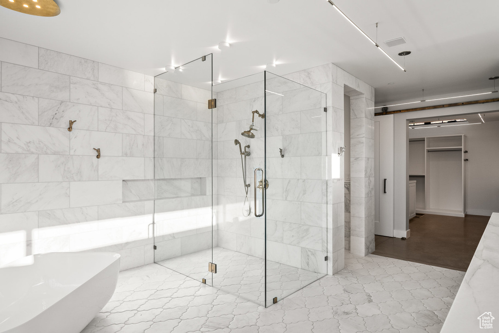 Bathroom with a soaking tub and a stall shower