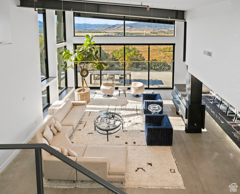 Sunken living room featuring a high ceiling and a mountain view