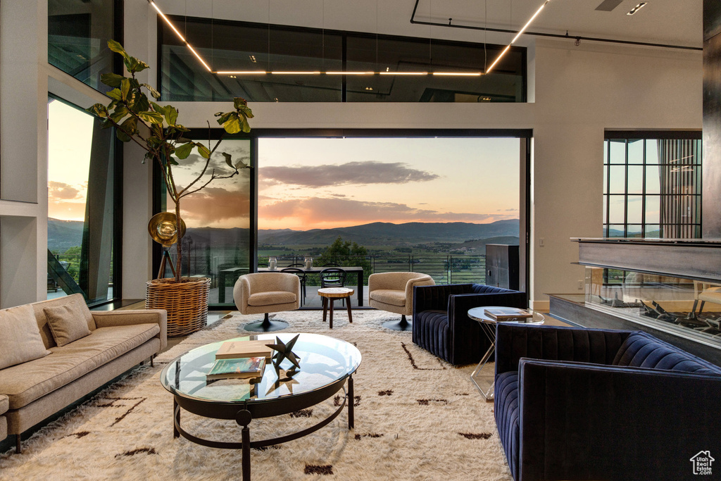 Living area with a towering ceiling and a mountain view