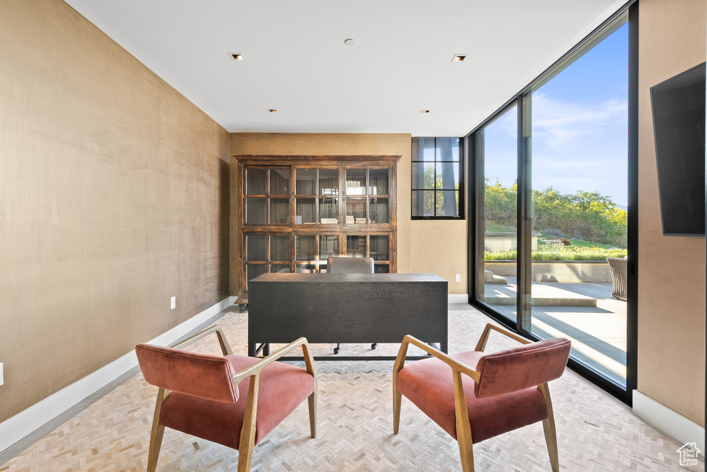 Office with a wall of windows and baseboards