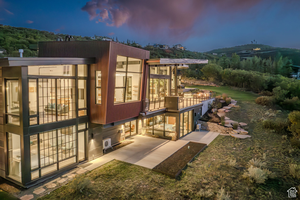 Rear view of property with a patio and a sunroom