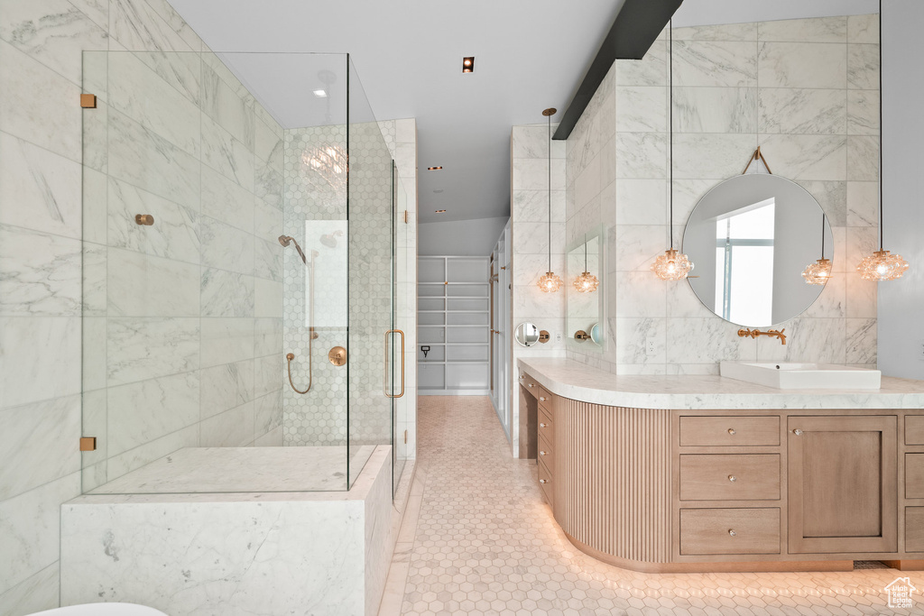Full bathroom with a shower stall, vanity, tile patterned floors, and a freestanding tub