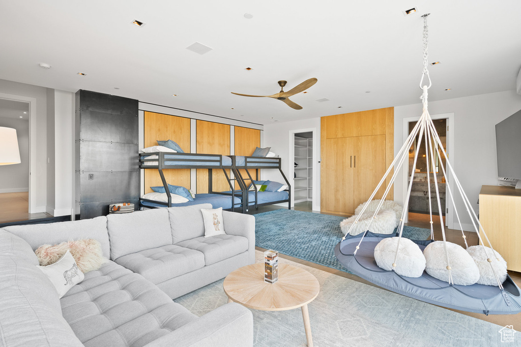 Living room with baseboards and a ceiling fan