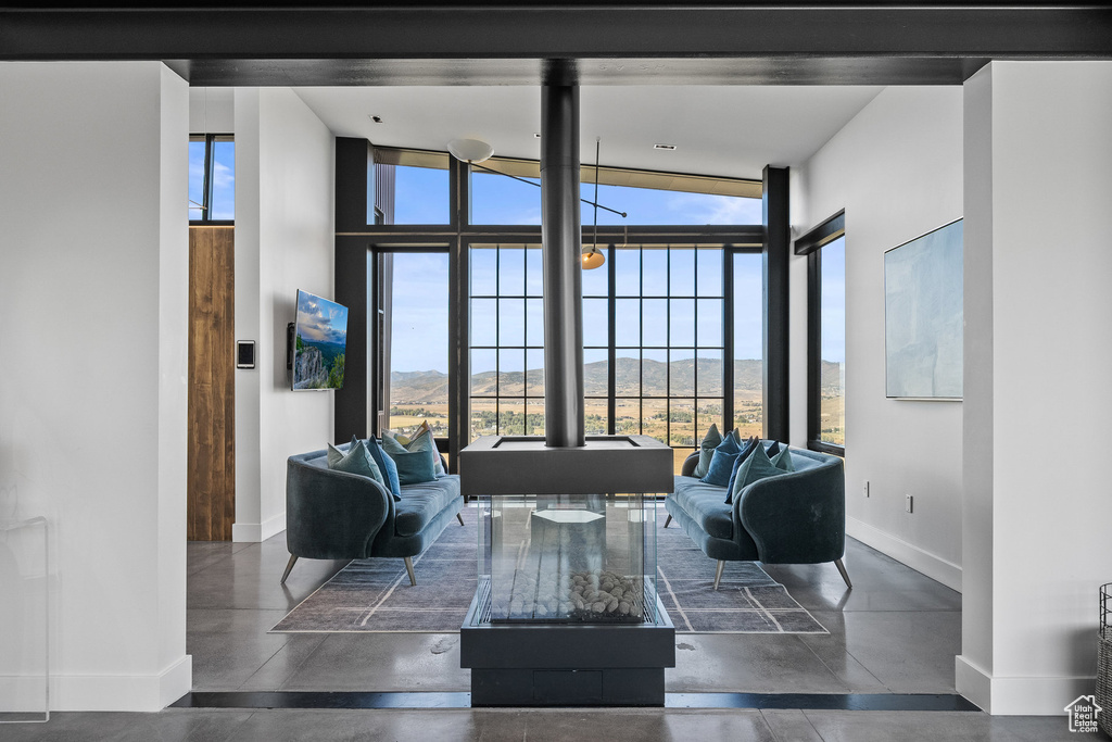 Living area with finished concrete flooring and expansive windows
