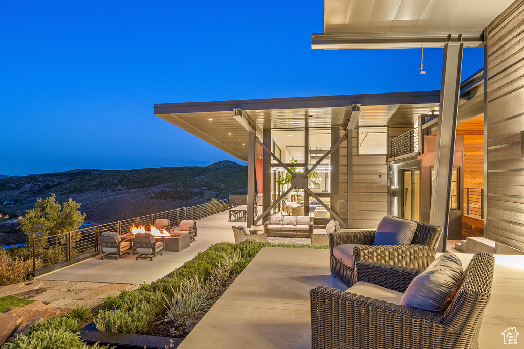 View of patio with an outdoor living space with a fire pit and a mountain view