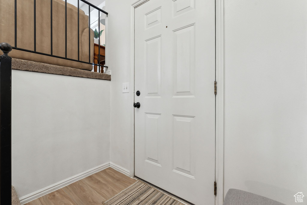 Doorway with light wood-type flooring