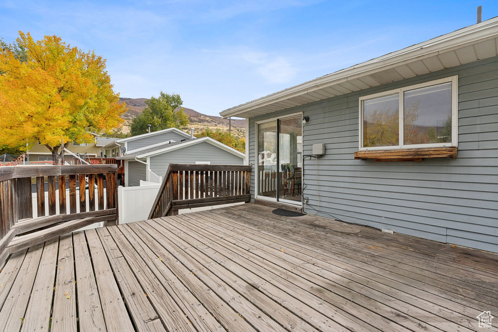 Wooden terrace featuring a mountain view