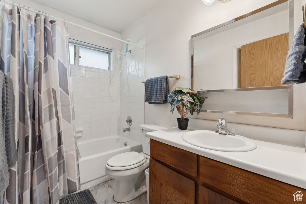 Full bathroom with vanity, toilet, and shower / bathtub combination with curtain