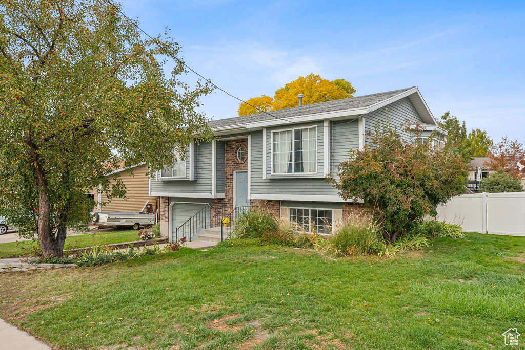 Raised ranch featuring a front lawn