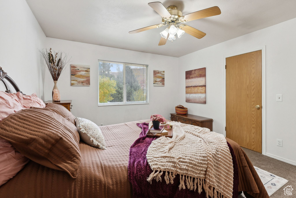 Carpeted bedroom with ceiling fan