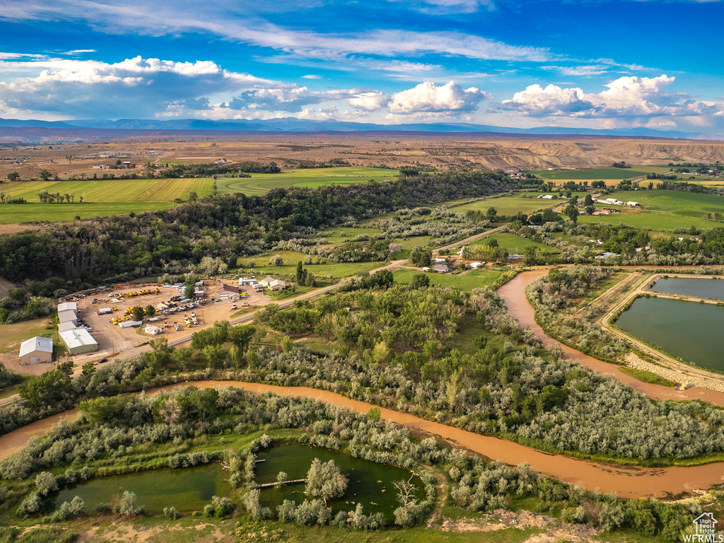 Drone / aerial view with a water view and a rural view