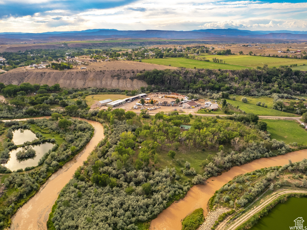 Birds eye view of property with a water and mountain view