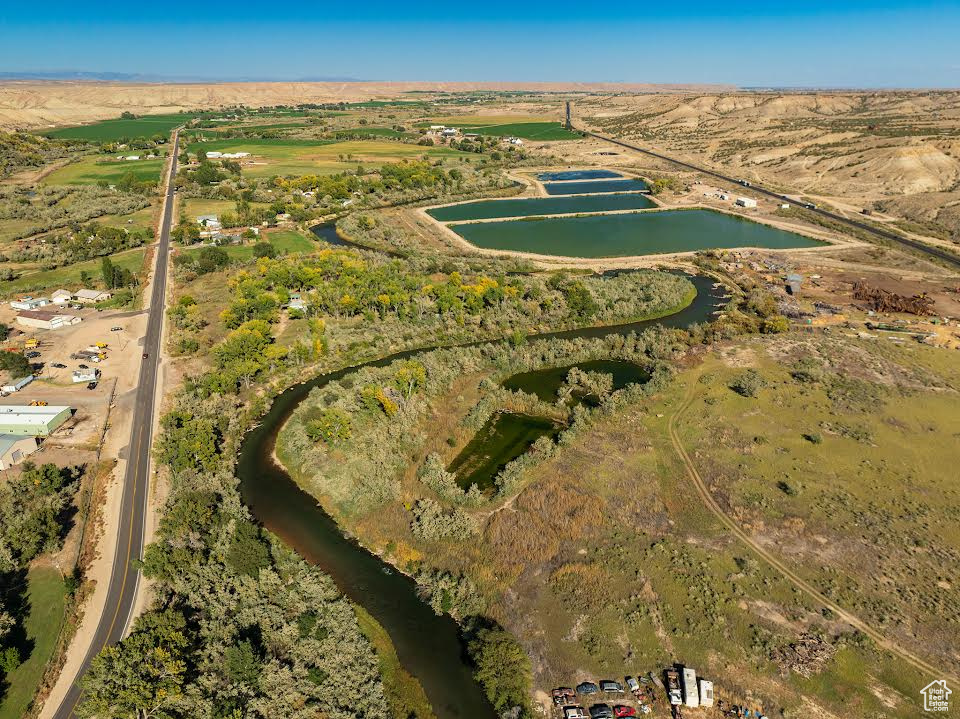 Birds eye view of property with a water view