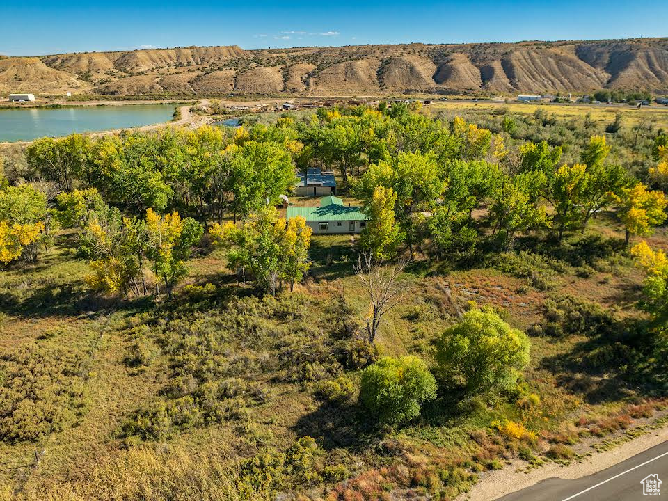 Birds eye view of property featuring a water and mountain view