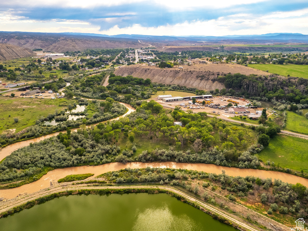 Drone / aerial view with a water and mountain view