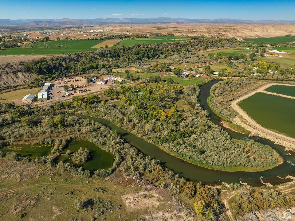 Drone / aerial view with a water view and a rural view