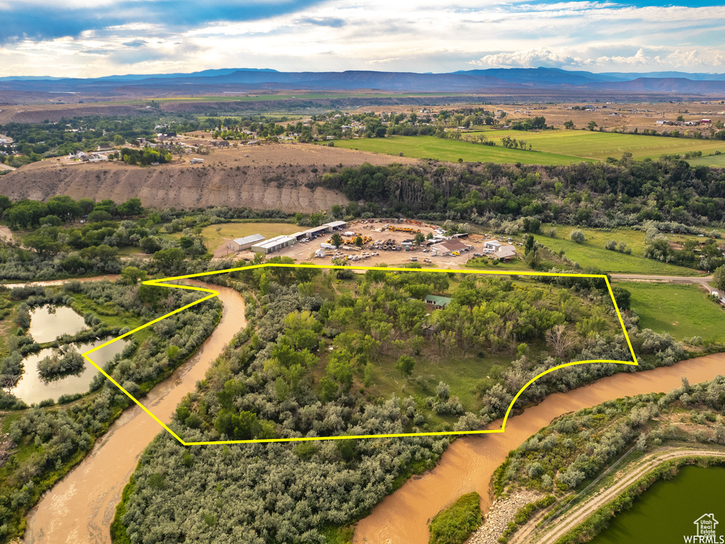 Drone / aerial view with a water and mountain view