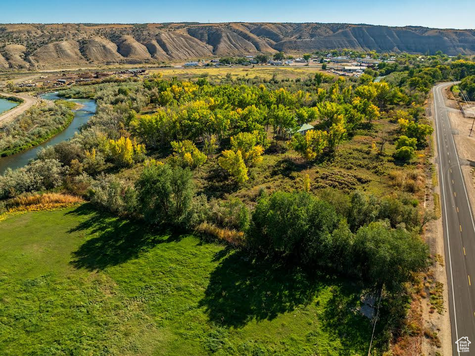 Birds eye view of property with a water and mountain view