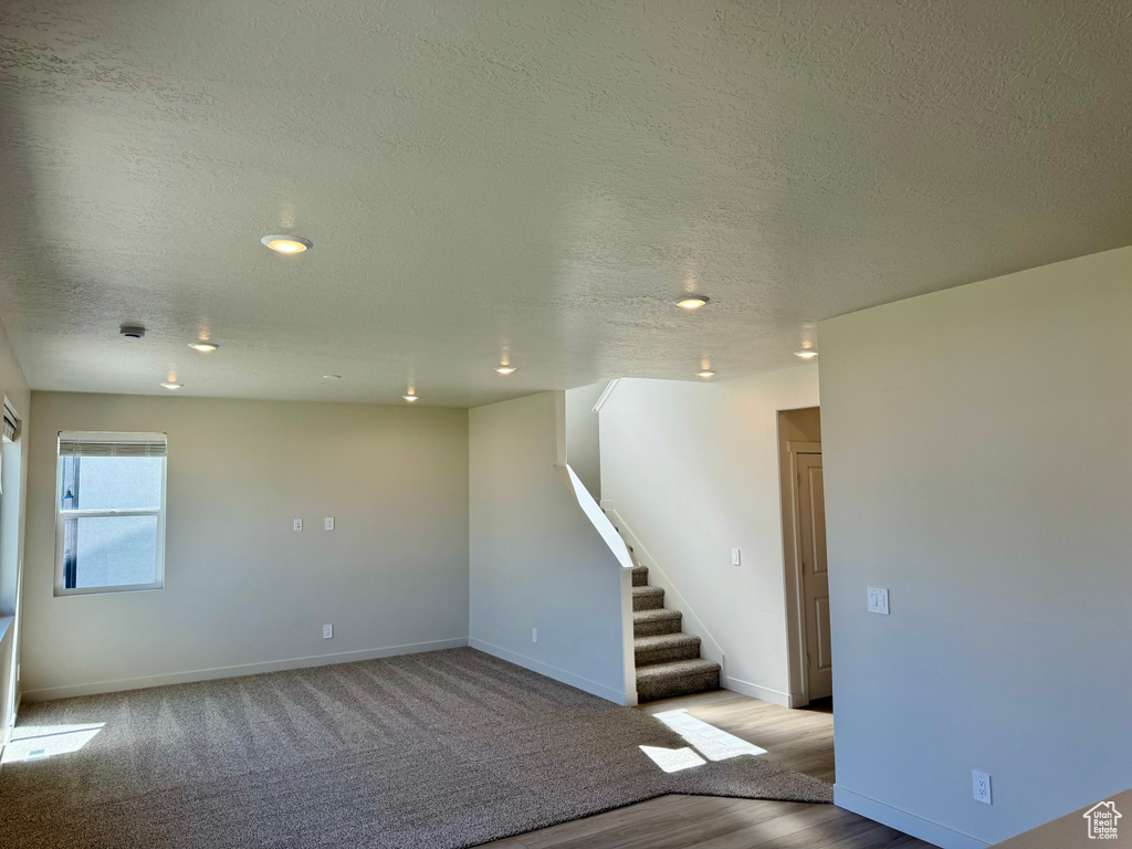 Unfurnished room featuring light hardwood / wood-style floors and a textured ceiling