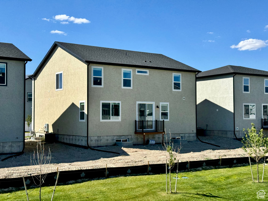 Rear view of property with a yard