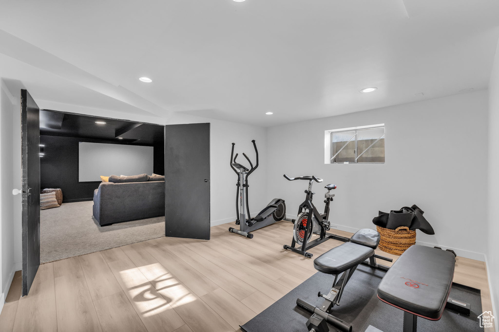 Exercise room with light hardwood / wood-style flooring