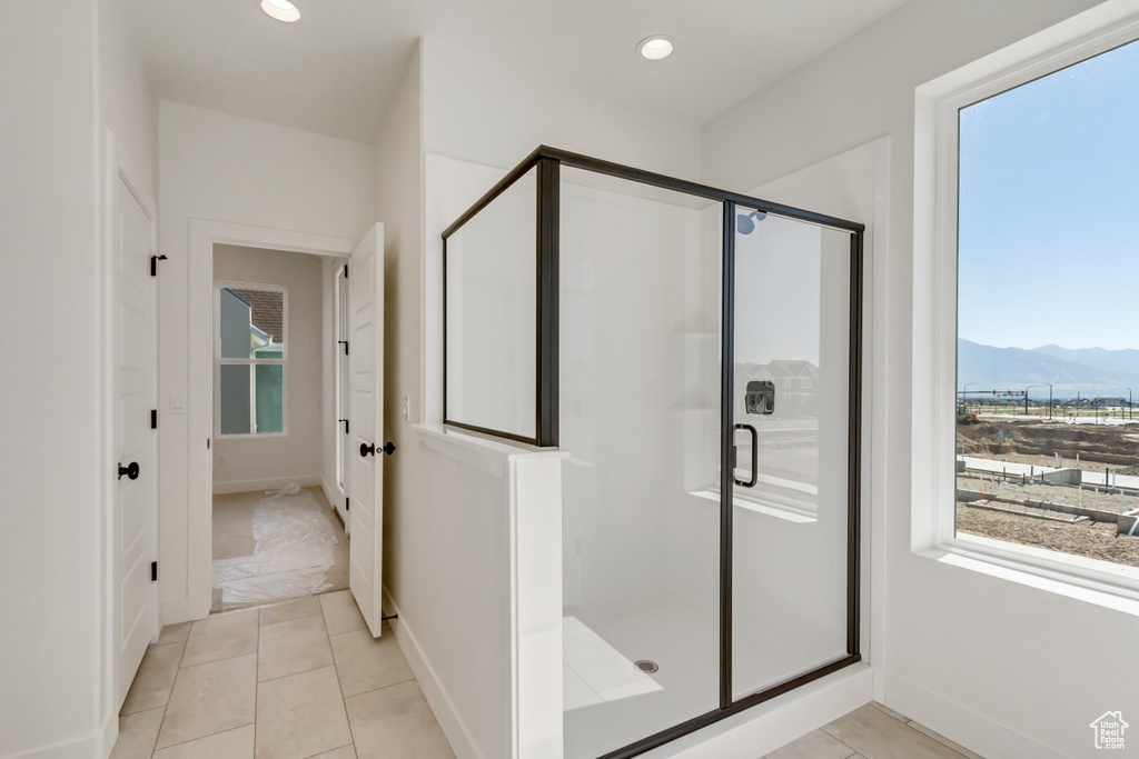 Bathroom featuring a mountain view, an enclosed shower, and tile patterned floors