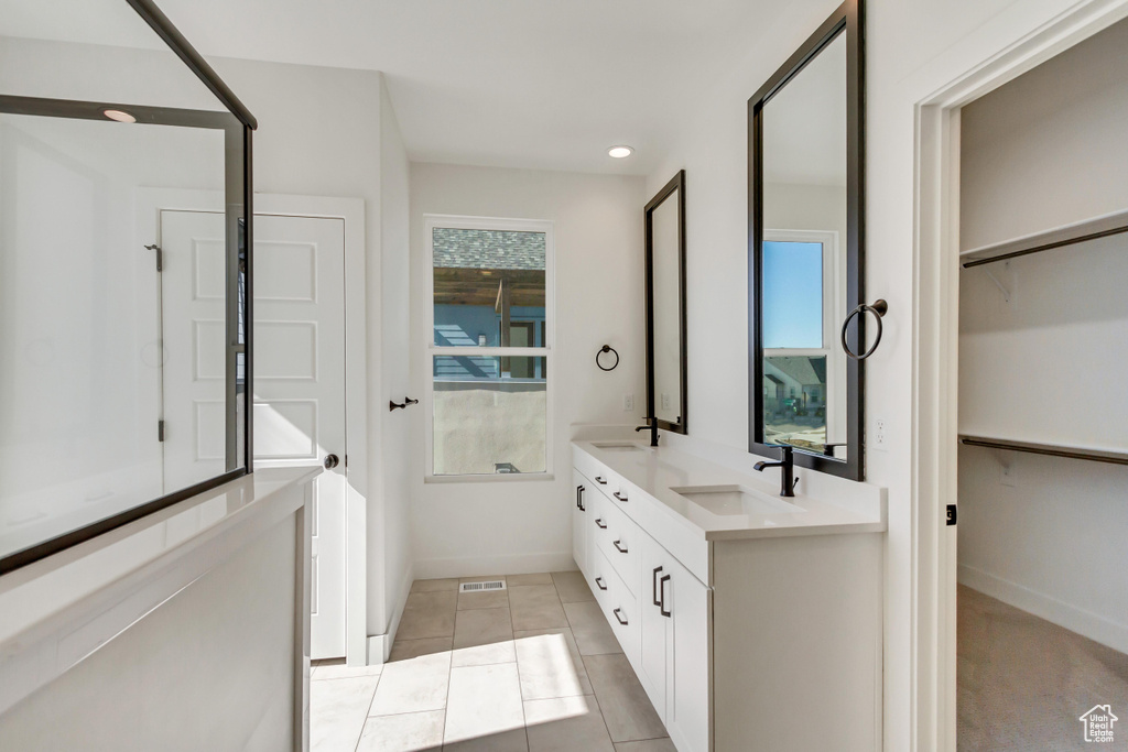 Bathroom with vanity and tile patterned flooring